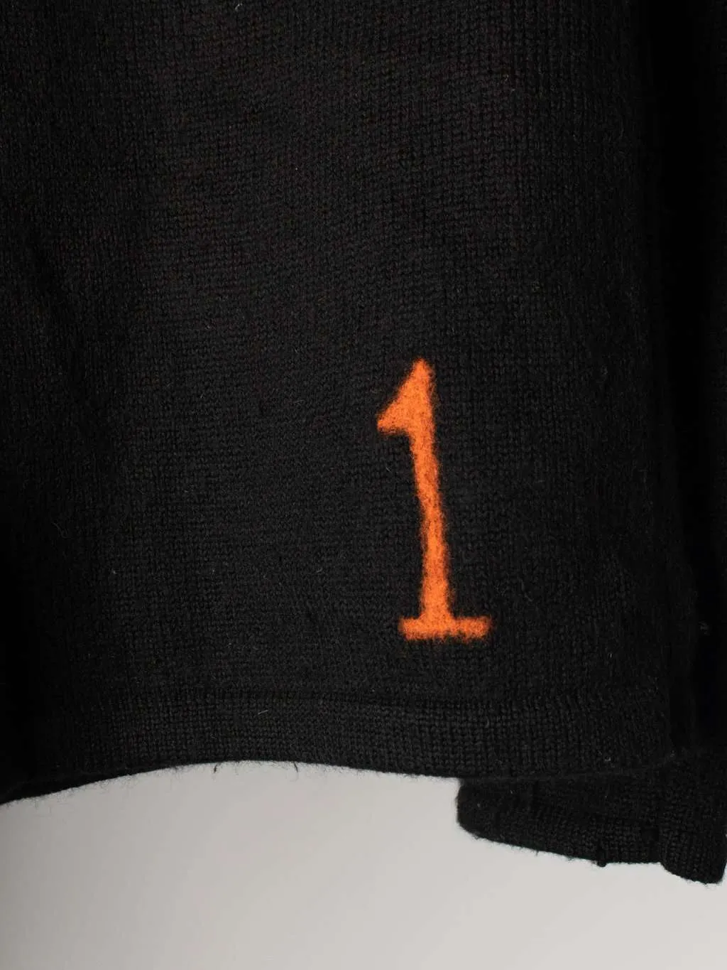 Merino wool plain black jumper with neon orange number ‘1’ detail – Medium